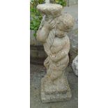 A 28 1/2" concrete bird bath base in the form of a putto holding a shell