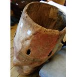 An antique African drum body carved from a single piece of wood, with painted relief carving of a