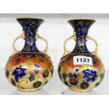 A pair of early 20th Century H. & R. Carlton Ware Best two handled bottle vases - one a/f