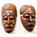 Two tourist ware carved wood masks with beaded and conch shell decoration