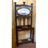 A 34" early 20th Century stained walnut hallstand with central bevelled oval mirror plate,