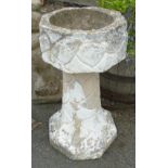 A 2' 6" faceted stone wall pattern pedestal planter