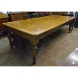 A 9' 6" polished oak and chequer board strung solid topped dining table with moulded canted