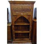 A 3' 1 1/2" far eastern hardwood three shelf open bookcase with moulded cornice and ornate carved