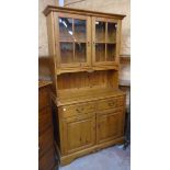 A 3' 5 1/2" modern pine two part dresser with glazed top section over a base with two short