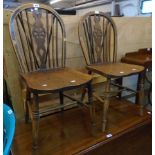 A pair of antique hoop wheel back standard chairs with solid seat panels and ring turned