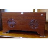 A 35 1/2" 20th Century Chinese camphor wood lift-top linen chest with carved roundel decoration to