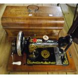 An early 20th Century German made Stoewer AG Saxonia type sewing machine under an inlaid wooden