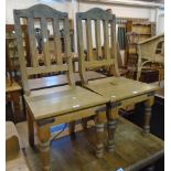 A set of four eastern iron decorated dining chairs with solid seat panels and bracketed turned front