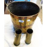Two shell cases and a copper bound brass fire bucket - no handle, hole in bottom