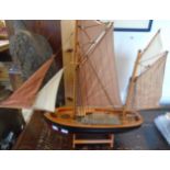 A painted wood model of a Brixham trawler