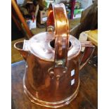 A late 19th-early 20th Century copper hot water jug with swing handle