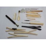 A collection of antique bone crochet hooks, glove stretchers, tatting spoon, etc.