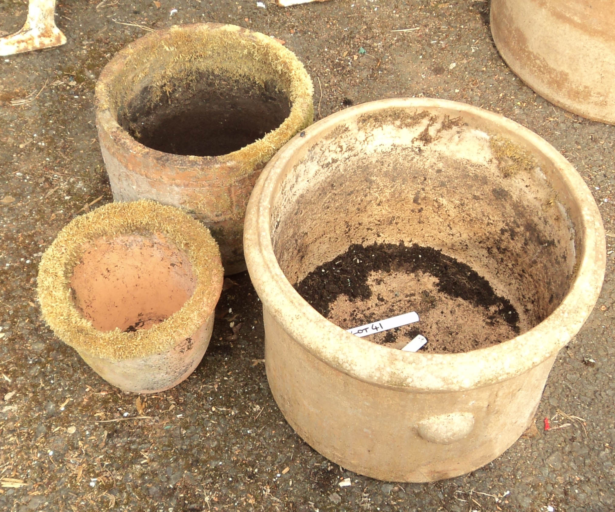 A 15 1/2" weathered terracotta plant pot - sold with two smaller similar