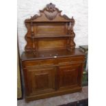 A 4' 3" continental walnut dresser with two shelves and turned supports to decorative raised back,