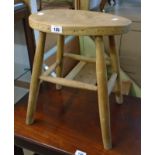 A vintage stool with solid elm seat and simple turned supports