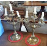 A pair of brass three branch candelabra