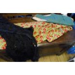 A box containing vintage clothing including a Victorian Medieval costume dress, a black Battenberg