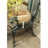 A pair of painted cast iron bench ends with wood inset armrests