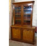 A 4' 9" Victorian mahogany two part book cabinet with moulded rounded cornice, applied decoration