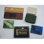 A collection of cards games including Canasta, Bezique, etc. - sold with a cribbage board and a pair