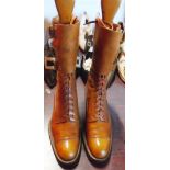 A pair of early 20th Century ladies brown leather ankle brogue boots with three buckles, complete