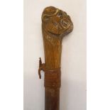 A walking stick with carved pug's head pommel