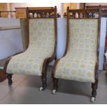 A pair of late Victorian stained walnut serpentine framed nursing chairs with spindle set backs