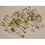 A collection of Grand Tour souvenir spoons in silver, .800 grade and other metal, many with