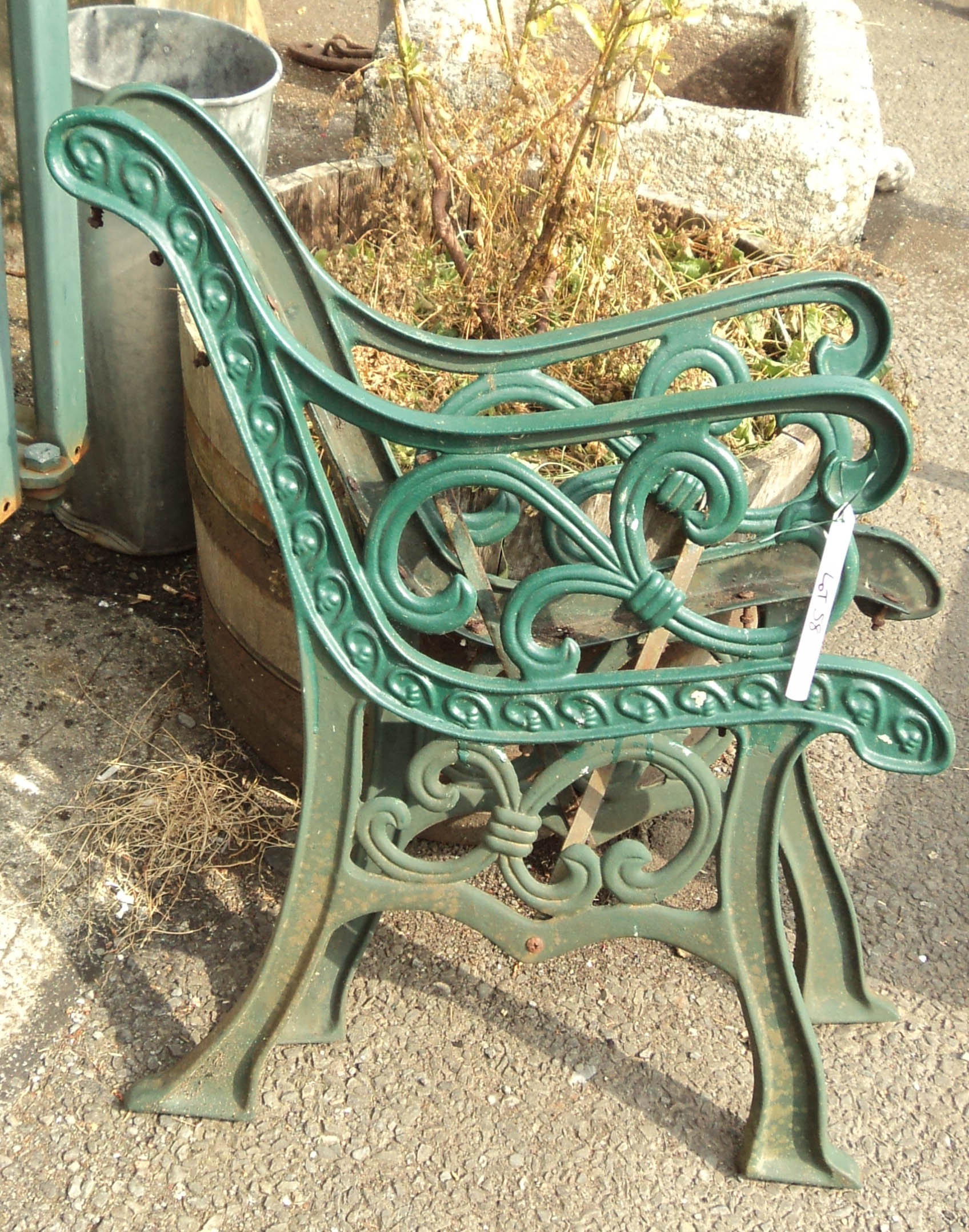 A pair of green painted cast iron bench ends