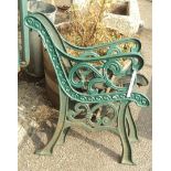 A pair of green painted cast iron bench ends