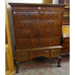 An early 19th Century figured walnut chest on stand with moulded dentil cornice, two short and three