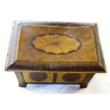 An old pressed tin tea caddy with inlaid wood effect printed finish