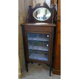 A 22 1/2" Edwardian inlaid walnut cabinet with oval bevelled mirror set raised back and three