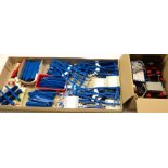 A quantity of vintage Lego Train pieces, including track, trucks, and transformer