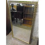 A pierced gilt framed bevelled oblong wall mirror