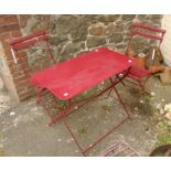 A painted metal framed bistro table and pair of chairs