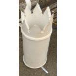 A white painted chimney pot with crowned top