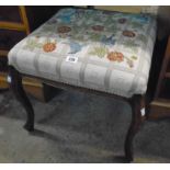 A Victorian mahogany framed dressing stool with later floral tapestry upholstery, set on cabriole