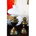 Two Victorian brass table oil lamps, both with chimneys, one with shade