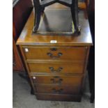 A 19 1/4" reproduction polished oak two drawer filing cabinet with leather inset top