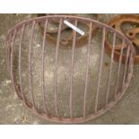 A vintage wrought iron wall mounted hay rack