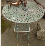 A 3' 3" diameter ornately pierced metal patio table on tripod base - sold with a small wrought