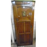 A 32 1/2" 20th Century polished oak hall wardrobe with applied moulded and pressed metal decoration,