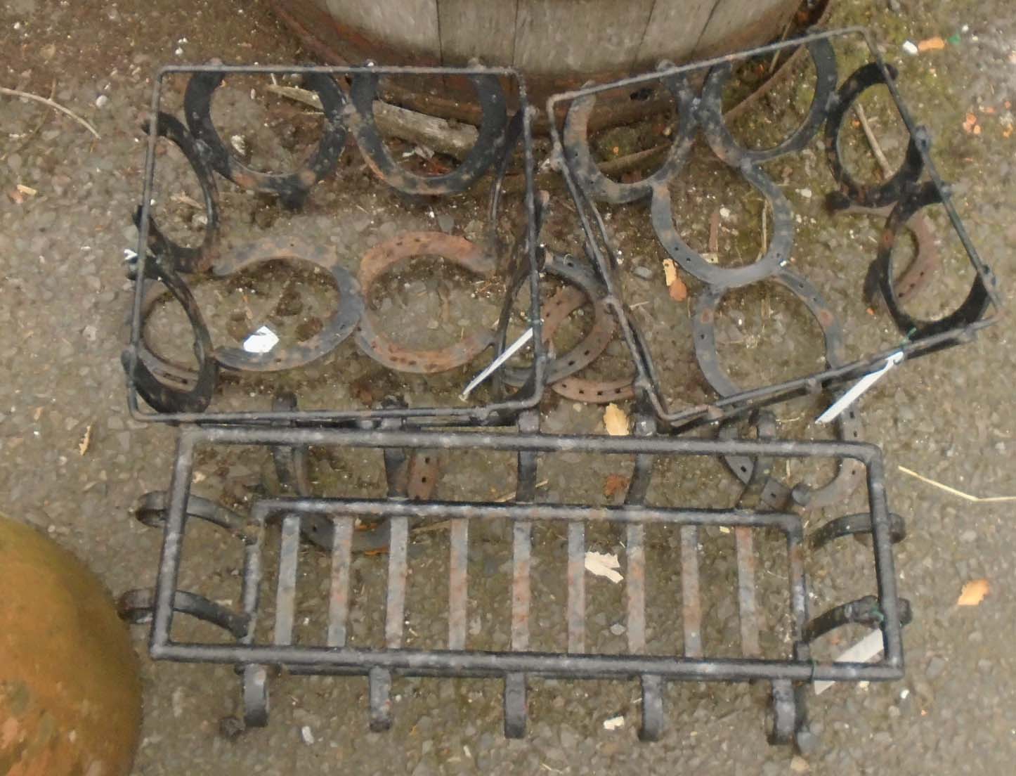 A pair of plant pot stands formed from horseshoes - sold with another