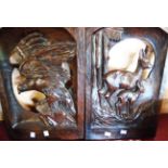 Two open carved wood panels depicting an eagle and a deer