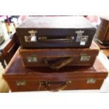 A vintage leather suitcase with remains of labels - sold with a small attaché case with Garstin's