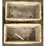 A pair of concrete rectangular planters