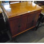 A reproduction mahogany and cross banded music cabinet by Charles Sheraton, Leeds, with lift-top and