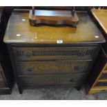 A 30" mid 20th Century stained oak chest of three long graduated drawers with moulded decoration